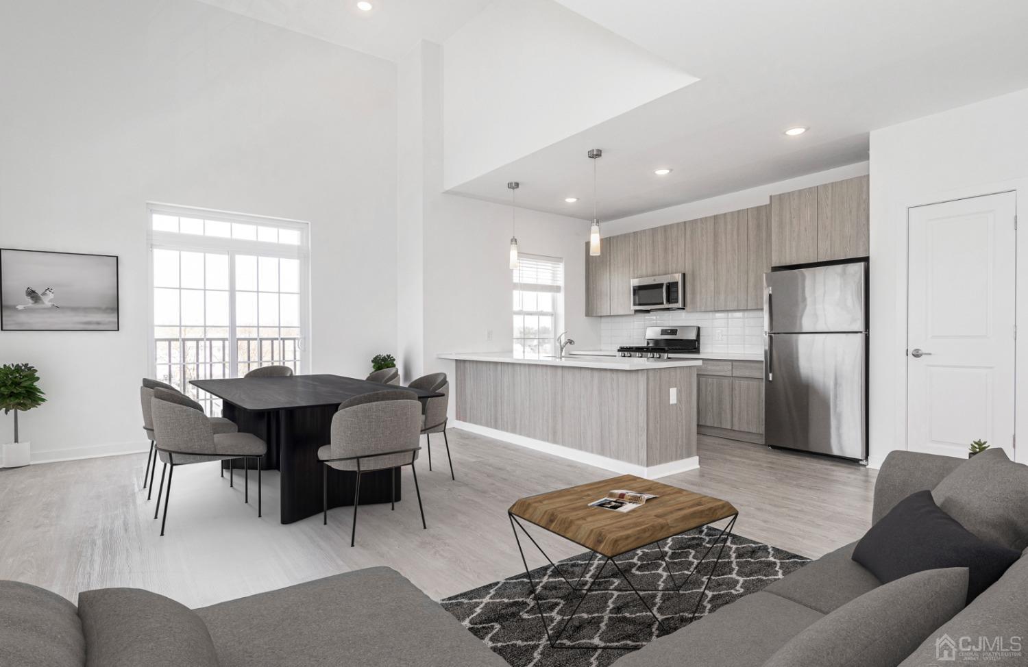 a living room with furniture a dining table and kitchen view