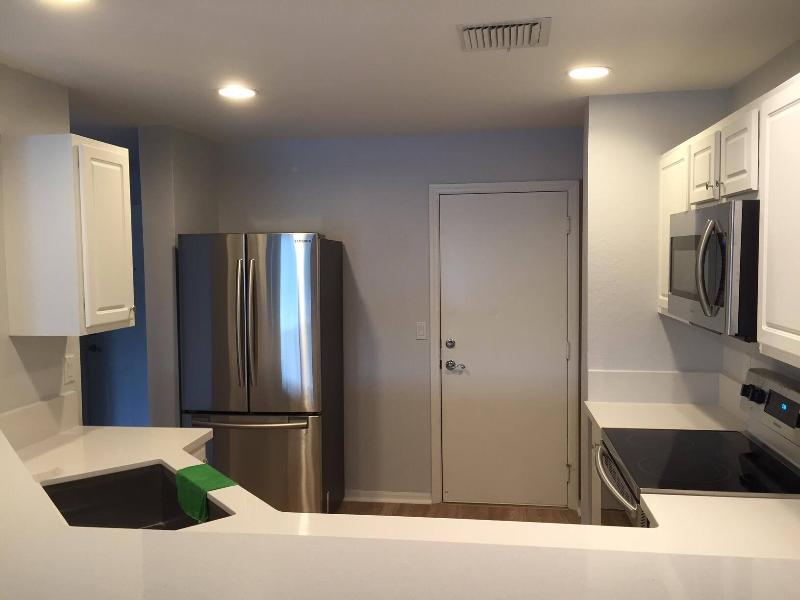 a kitchen with a refrigerator and a sink