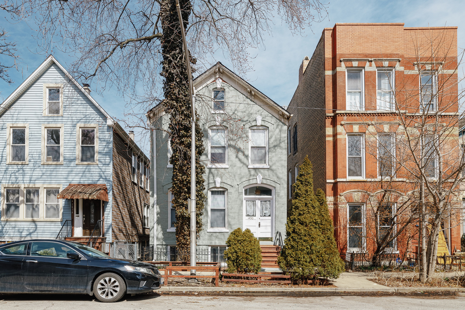 a front view of a residential apartment building with a yard