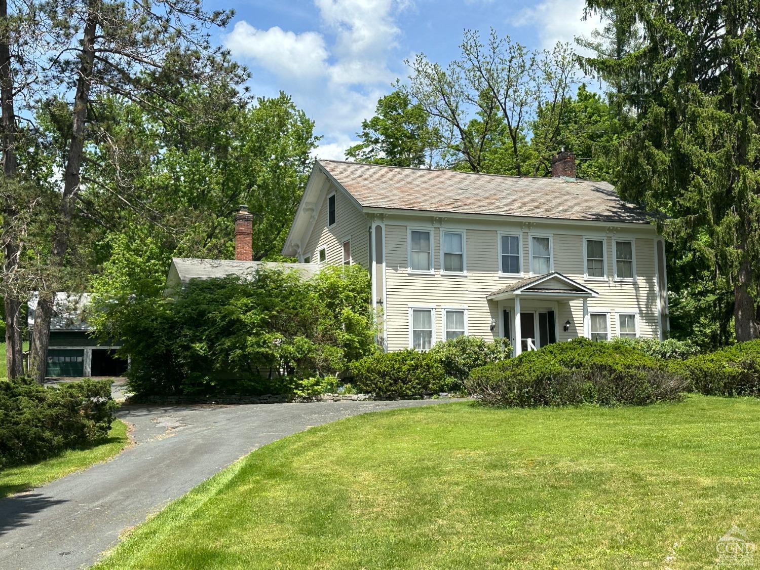 a front view of a house with a garden