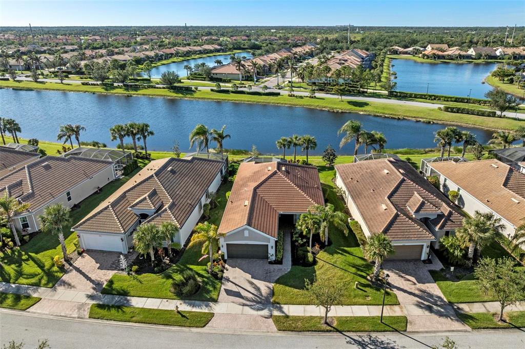 an aerial view of residential houses with outdoor space and river