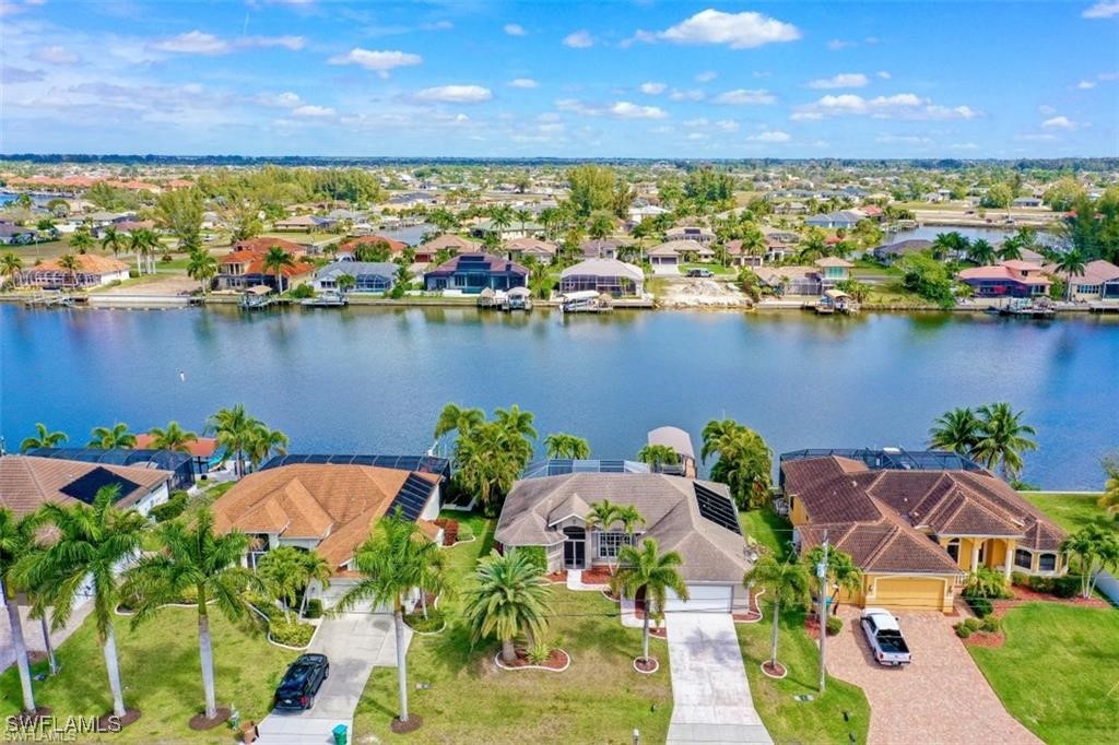 an aerial view of a house with a lake view