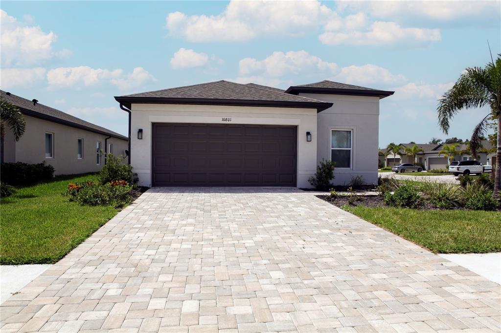 a front view of a house with a yard and garage