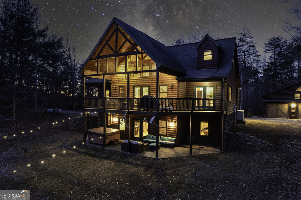 a view of a house with backyard and sitting area