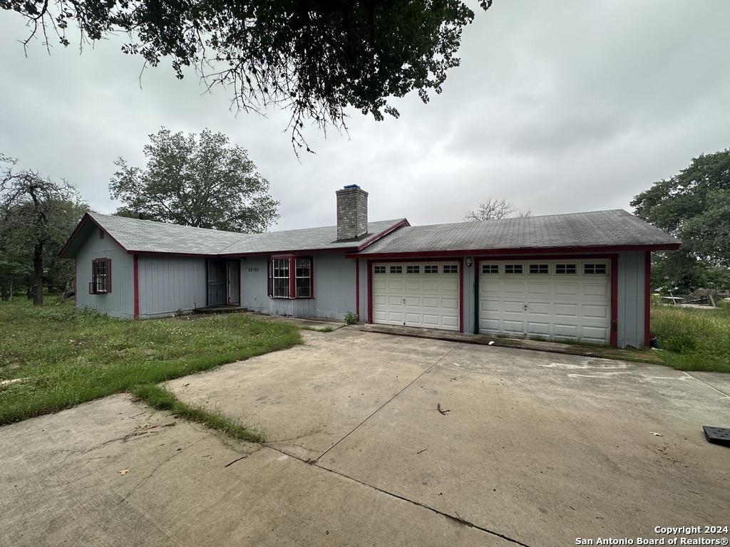 a view of a house with a yard and garage