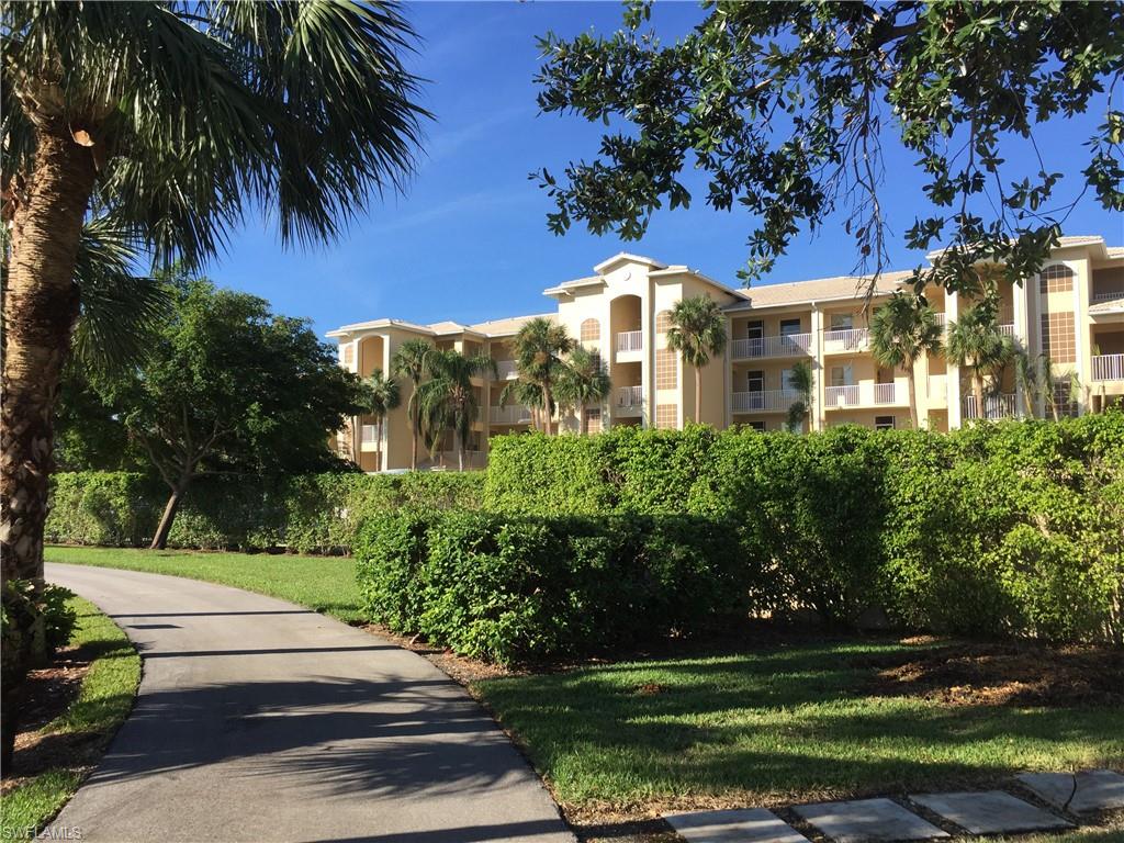 a front view of a multi story residential apartment building with a yard