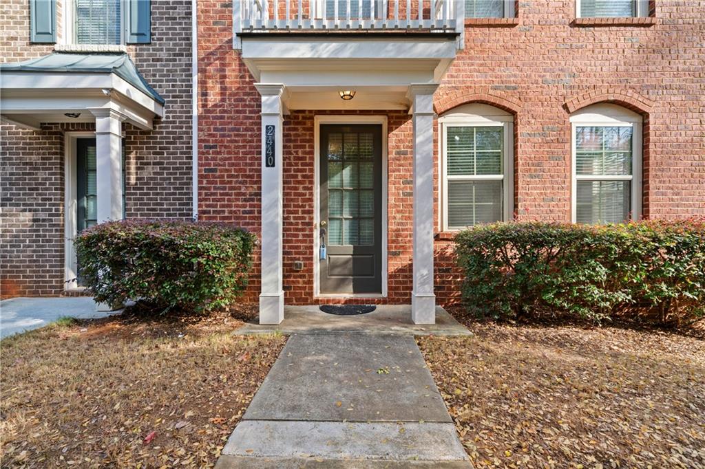 front view of a brick house with a yard