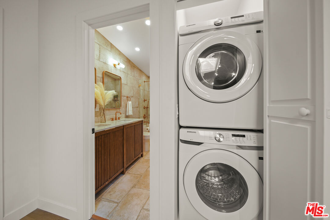 a view of a hallway with washer and dryer