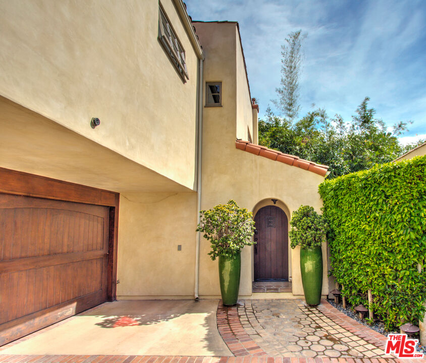 a couple of potted plants in front of door