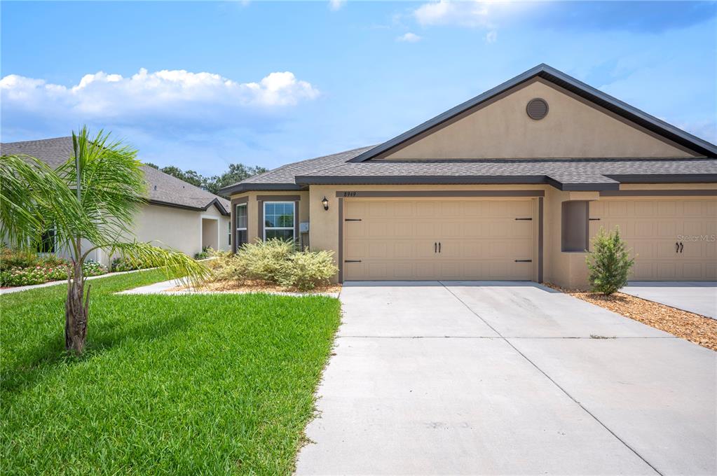 a front view of a house with a yard and garage