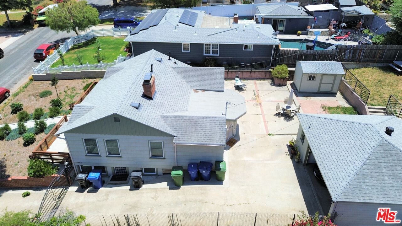 an aerial view of a house with a yard