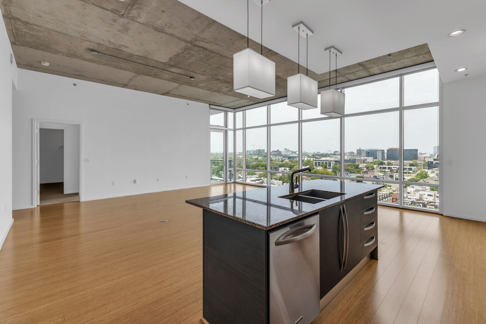 a kitchen with a sink and wooden floor