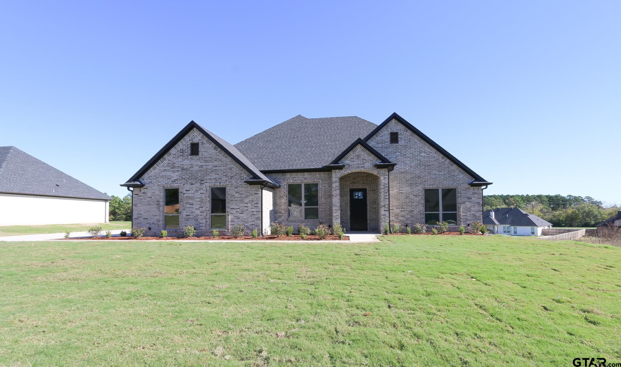 a front view of house with yard and and trees