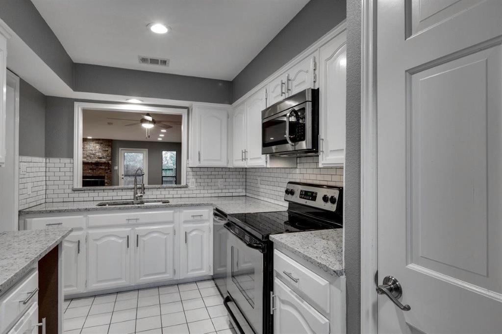 a kitchen with a sink stove and microwave