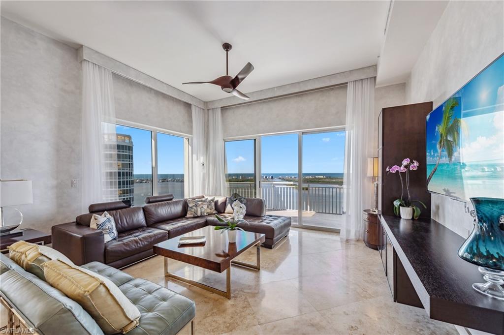 a living room with furniture ceiling fan and a rug