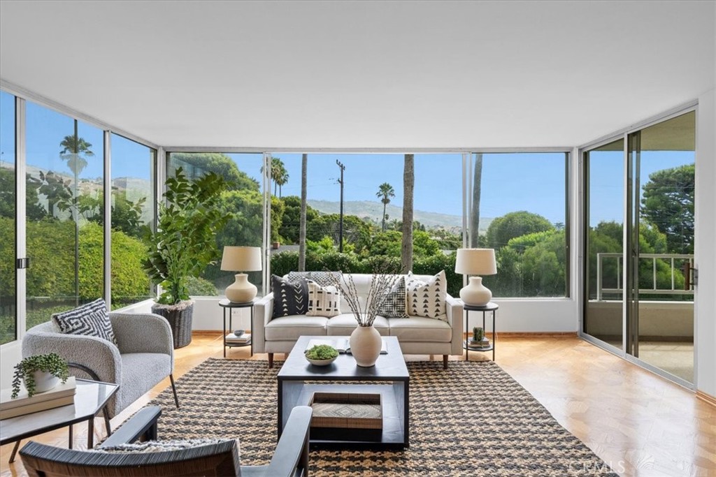 a living room with furniture and a floor to ceiling window