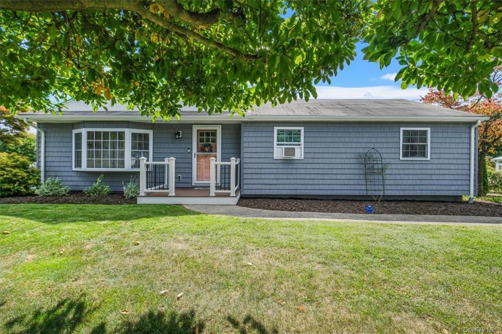 Single story home featuring a front lawn