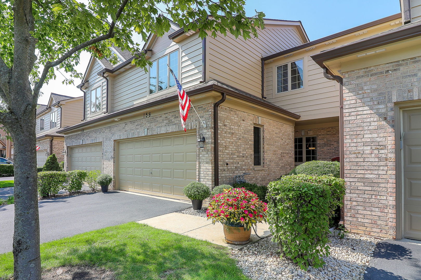 a front view of a house with a yard and a garage