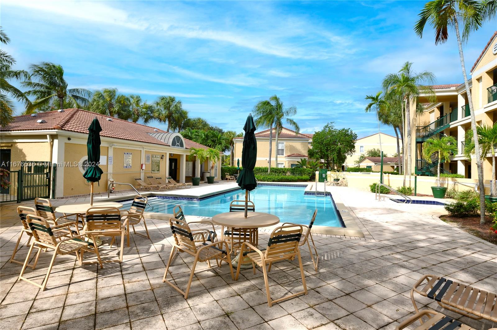 a view of a patio with a dining table and chairs with a fire pit