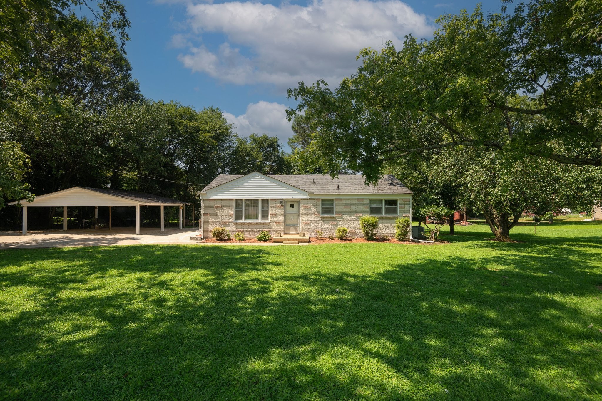 a front view of a house with a garden