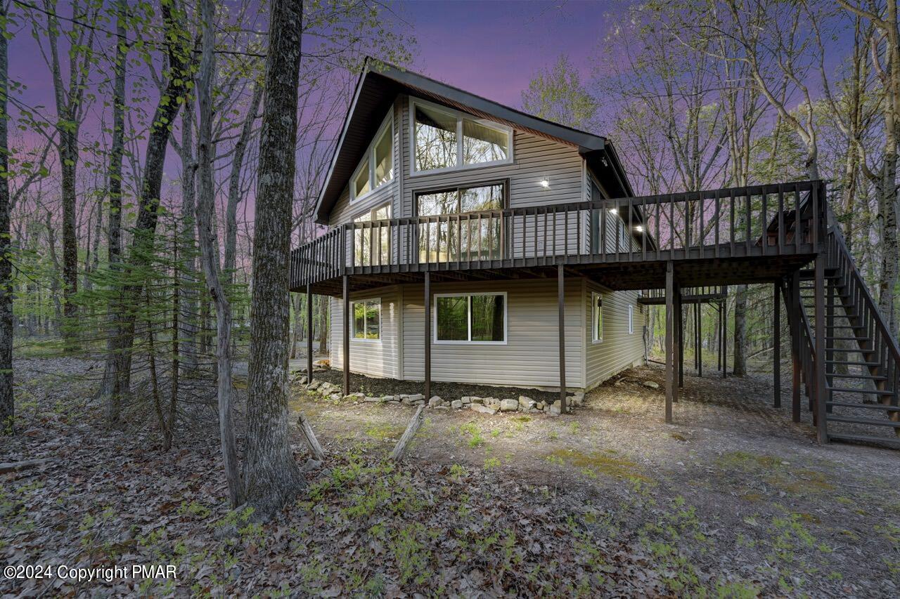 a view of an house with backyard space and balcony