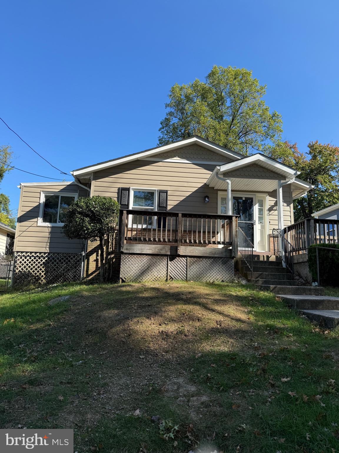 a view of a house with a yard deck and furniture