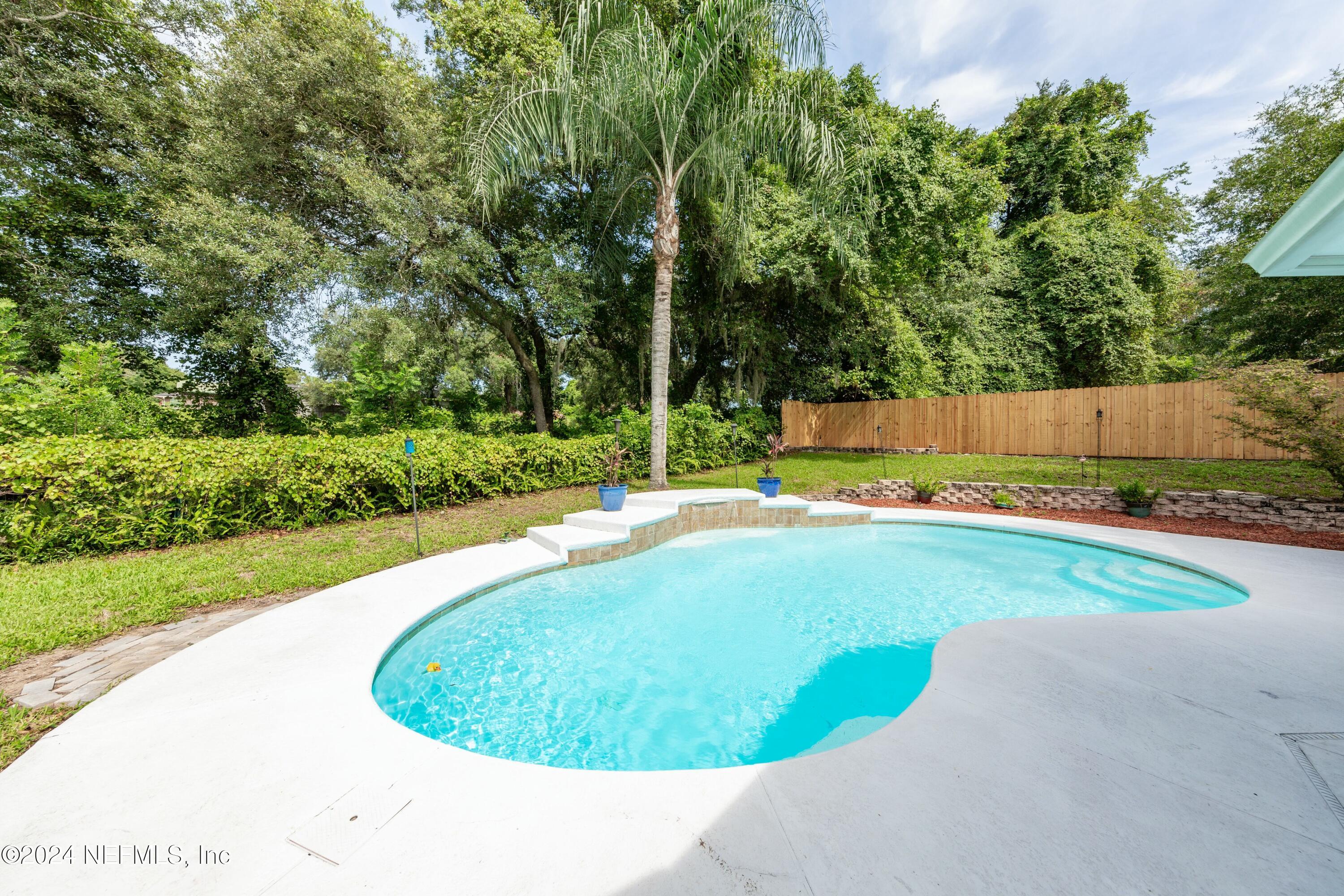 a view of a swimming pool with a yard