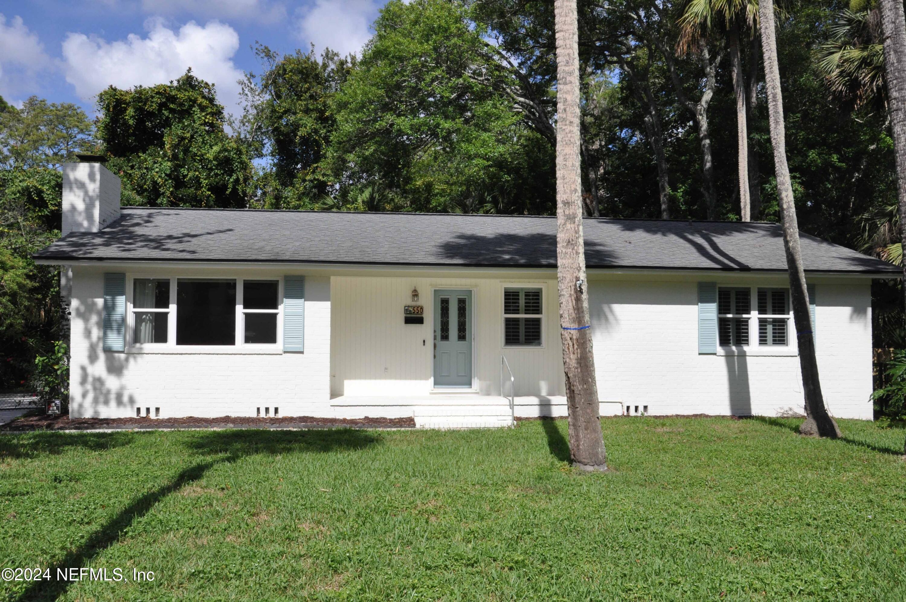 a view of house with backyard