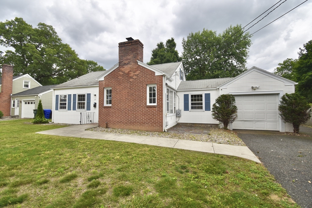 a front view of a house with a garden and yard