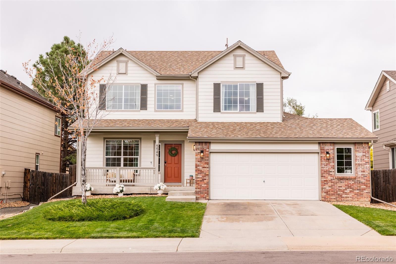 a front view of a house with a yard and outdoor seating