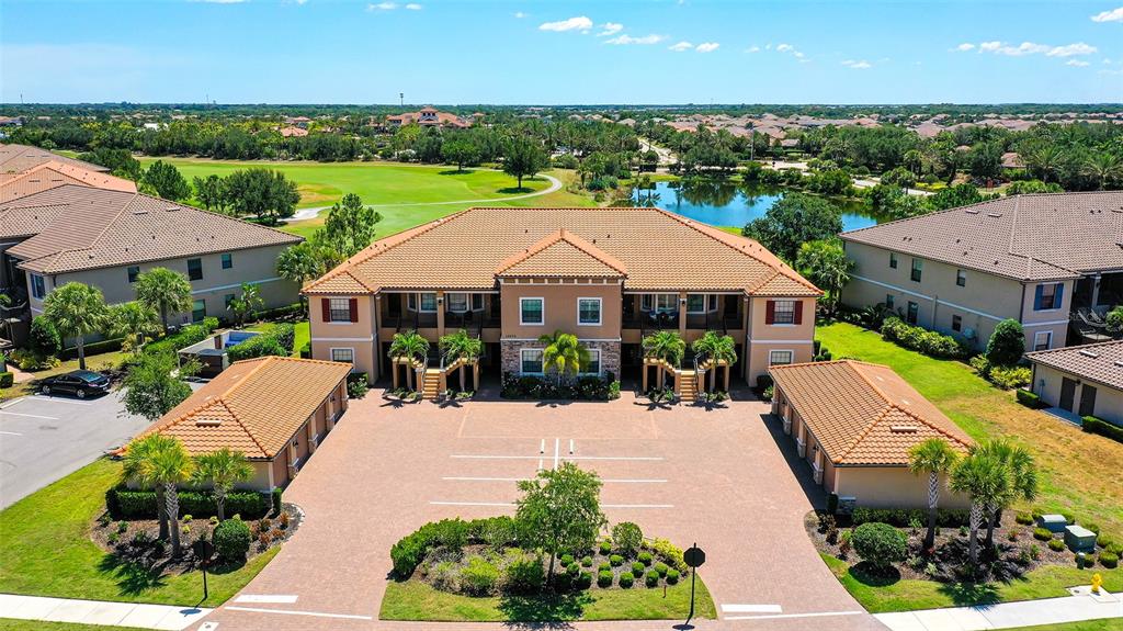 an aerial view of a house with a garden and lake view