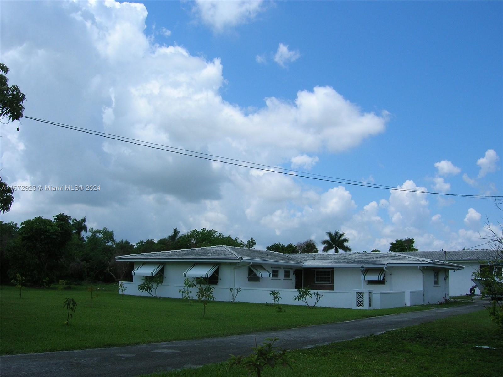 an aerial view of house with yard and entertaining space