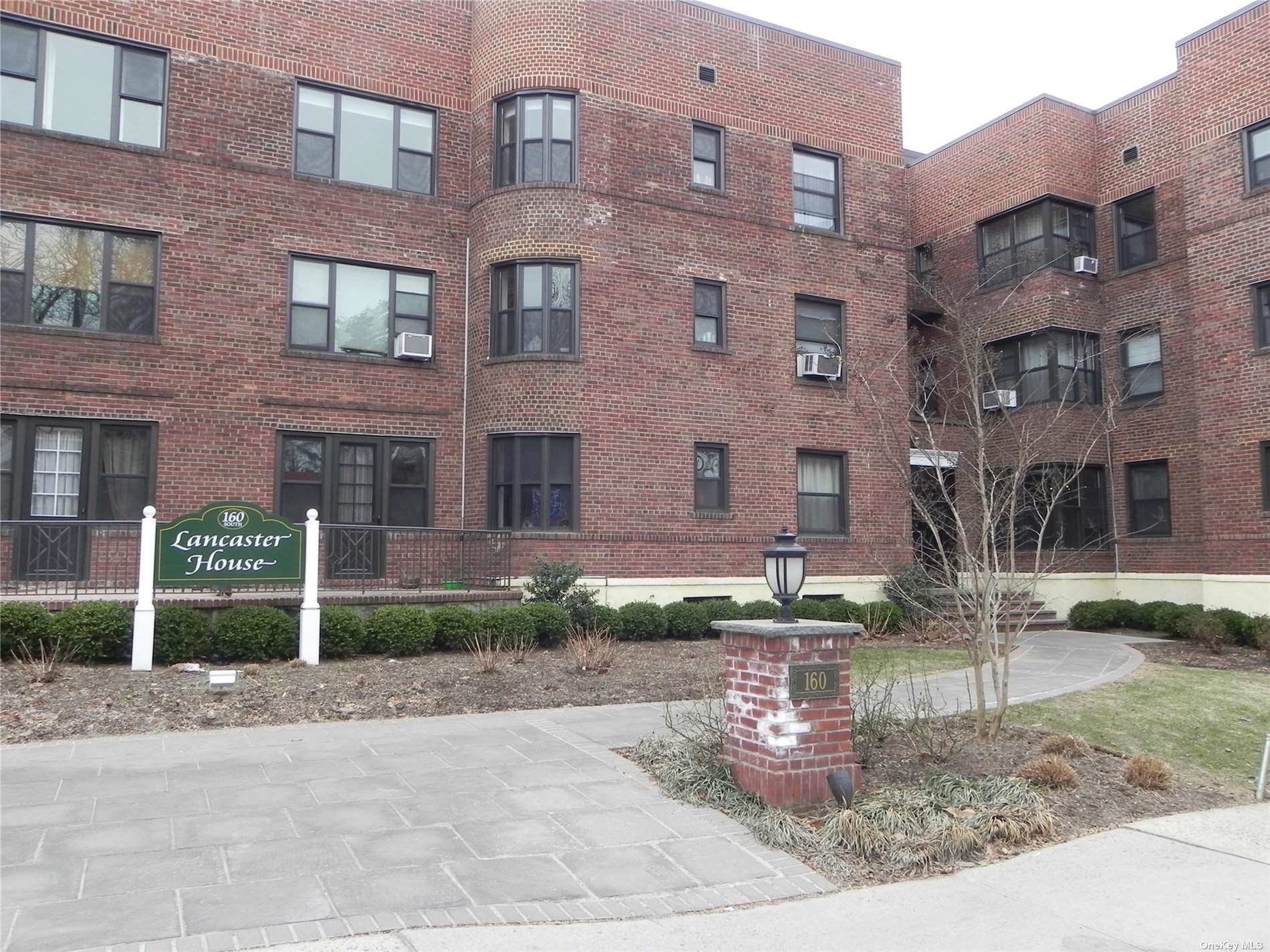 a view of a brick building with many windows