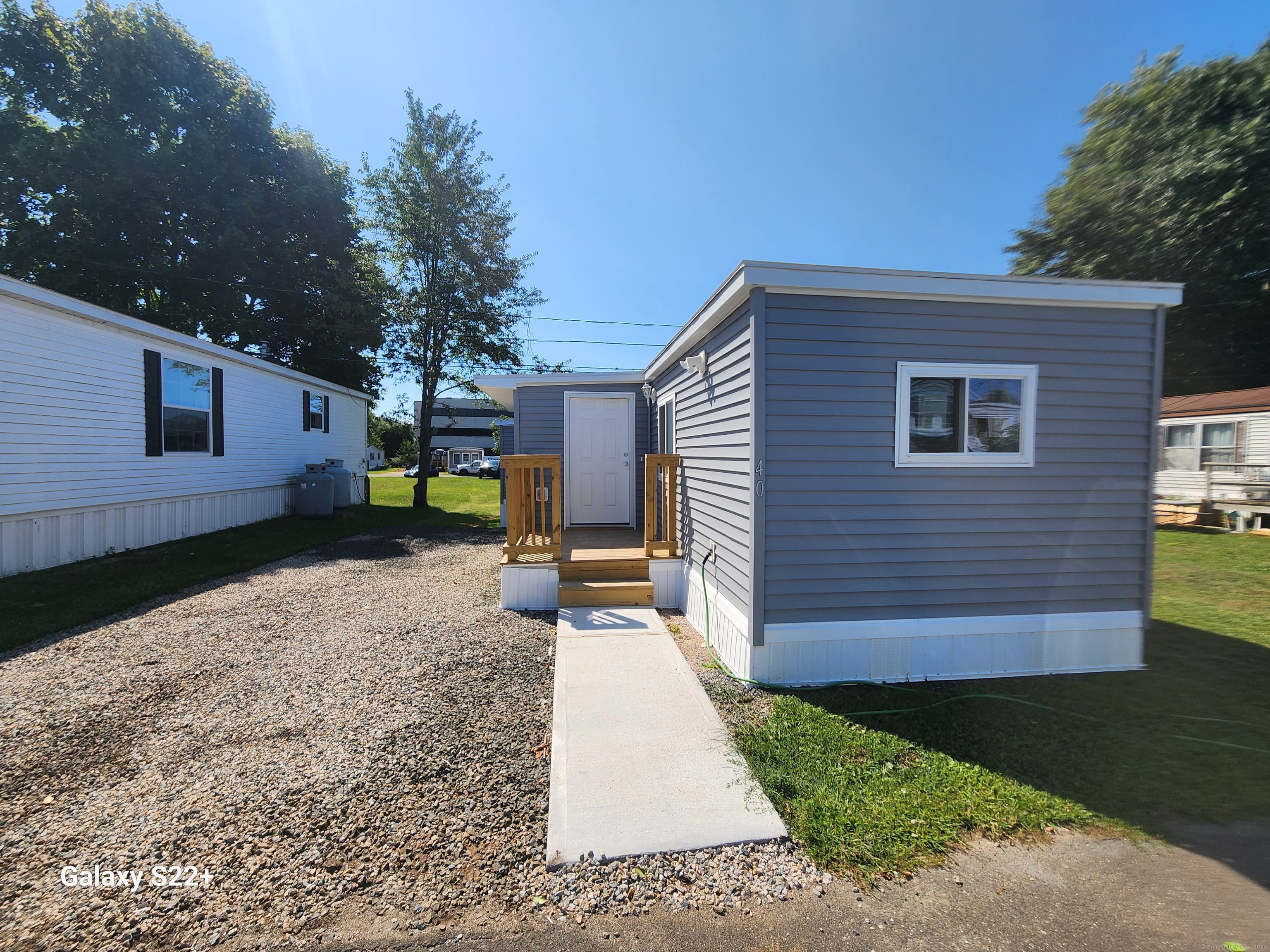 a pathway of a house with a yard