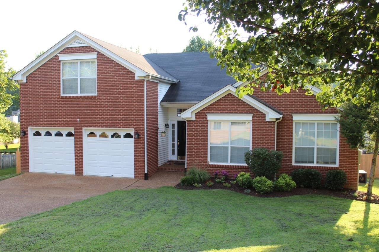 a front view of house with yard and green space