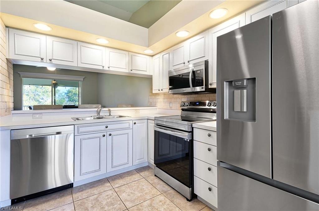 a kitchen with stainless steel appliances a refrigerator stove microwave and sink