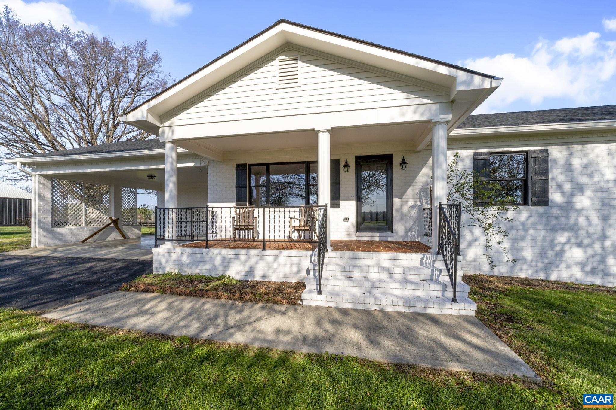 a view of a house with backyard and porch