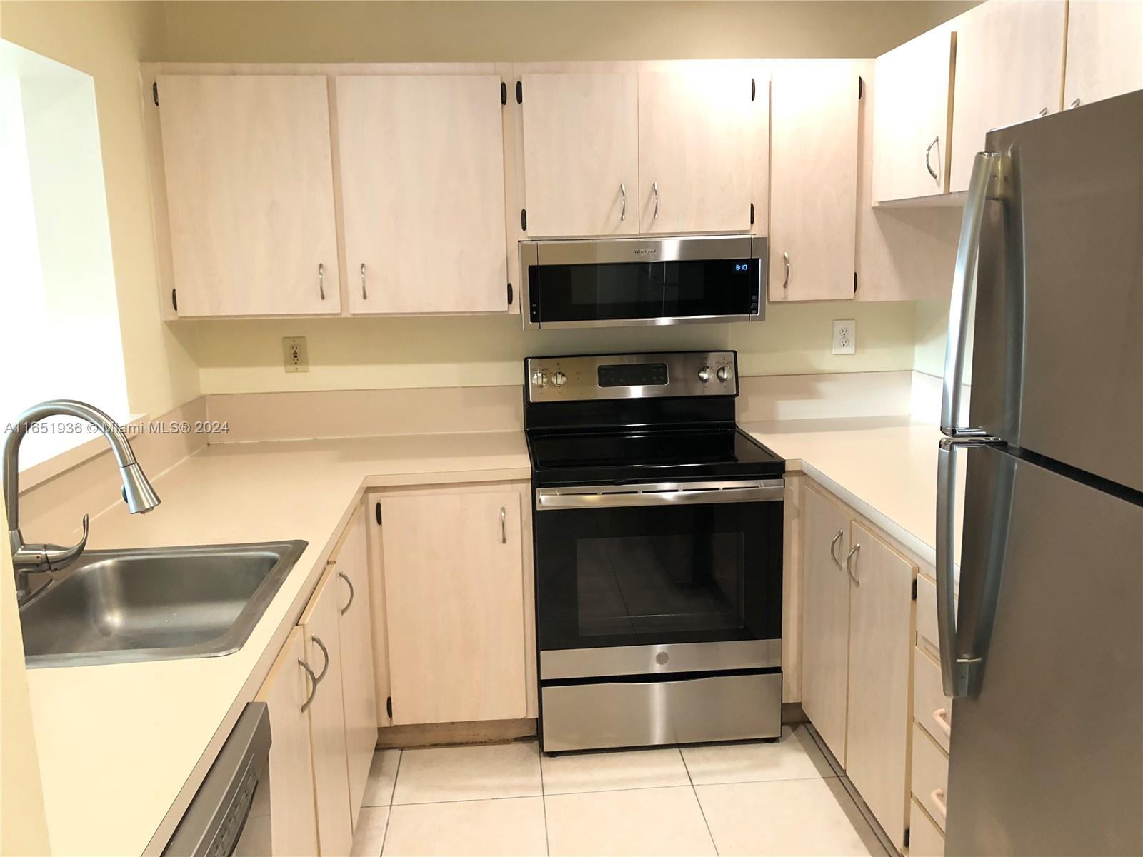 a kitchen with a sink and a refrigerator