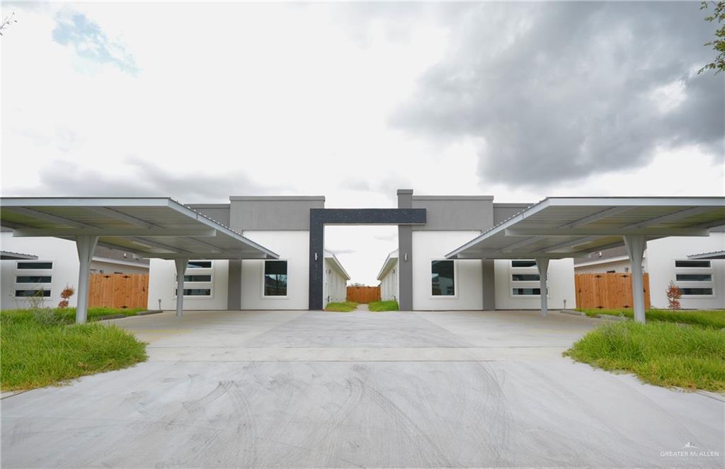 a view of a house with a patio and a yard