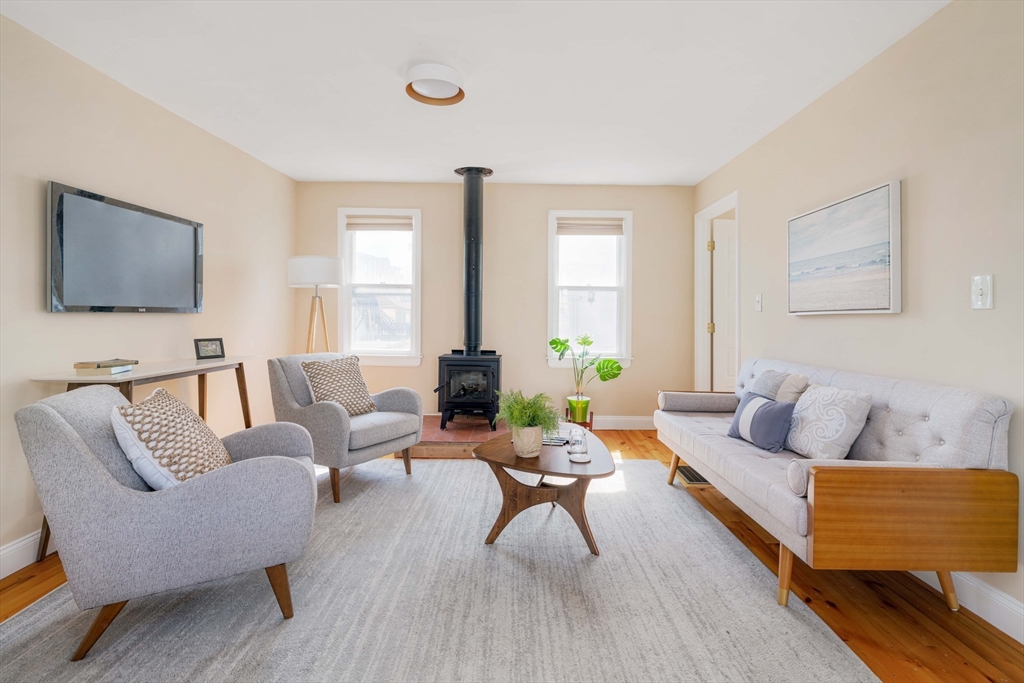 a living room with furniture and wooden floor