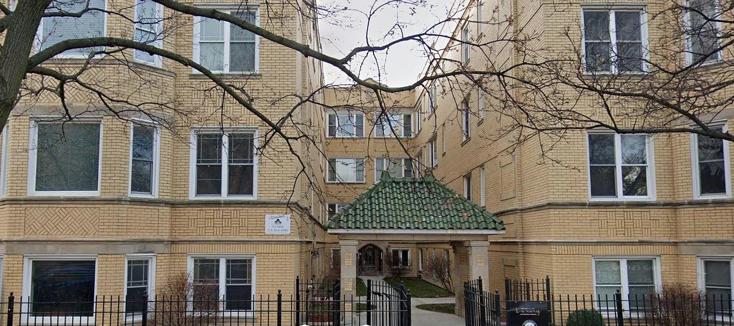 front view of a building with a tree