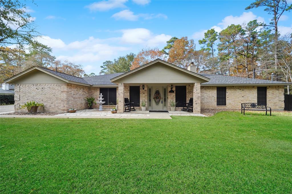 a front view of a house with yard and green space