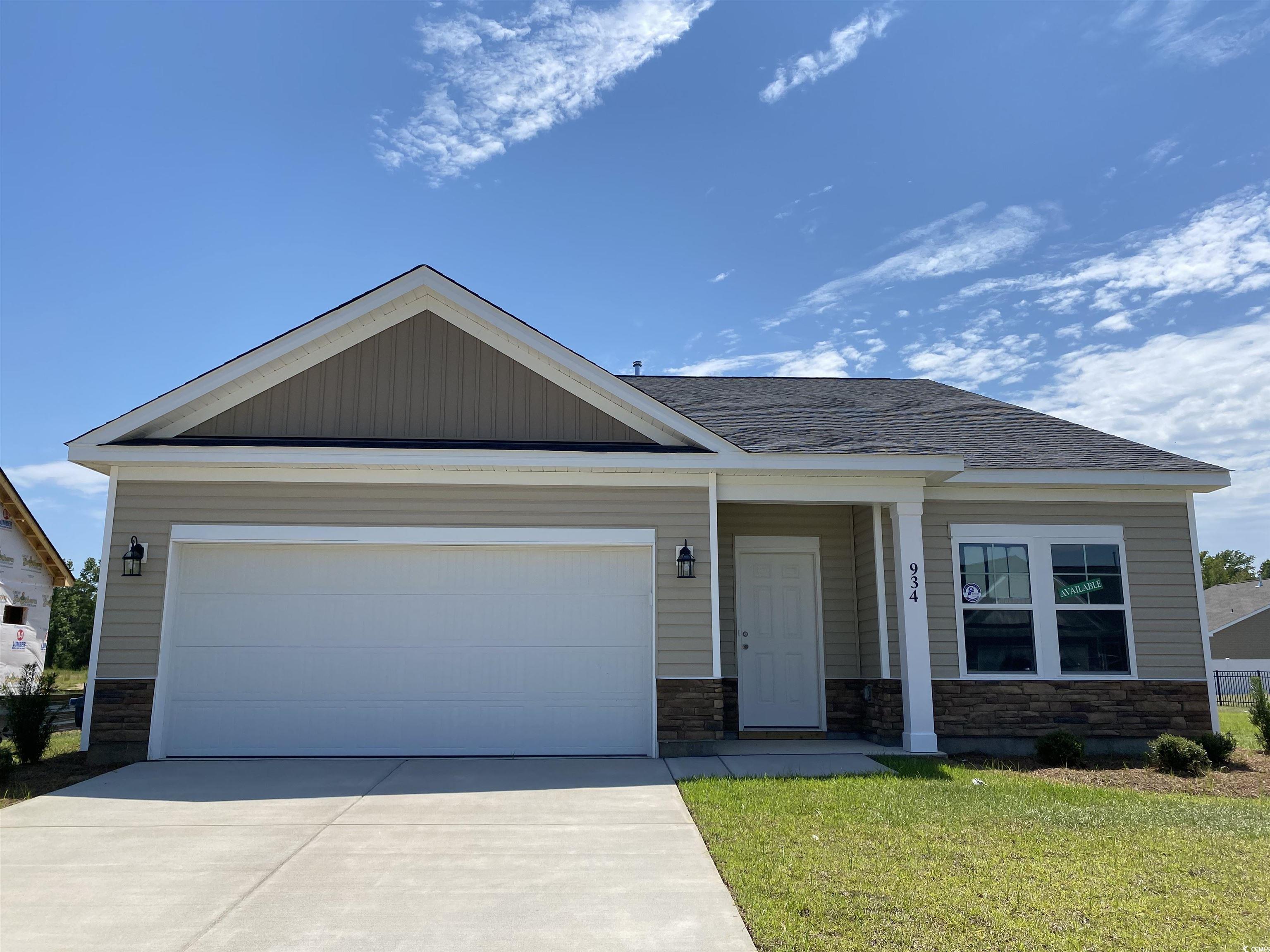 View of front facade with a garage and a front yar