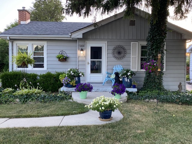 a front view of a house with yard and outdoor seating