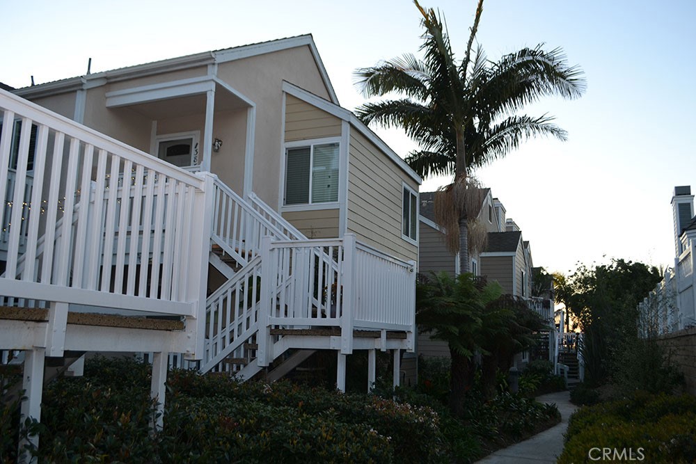 a view of a house with a yard and potted plants