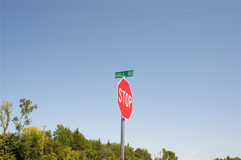 a street sign on a wall next to a road