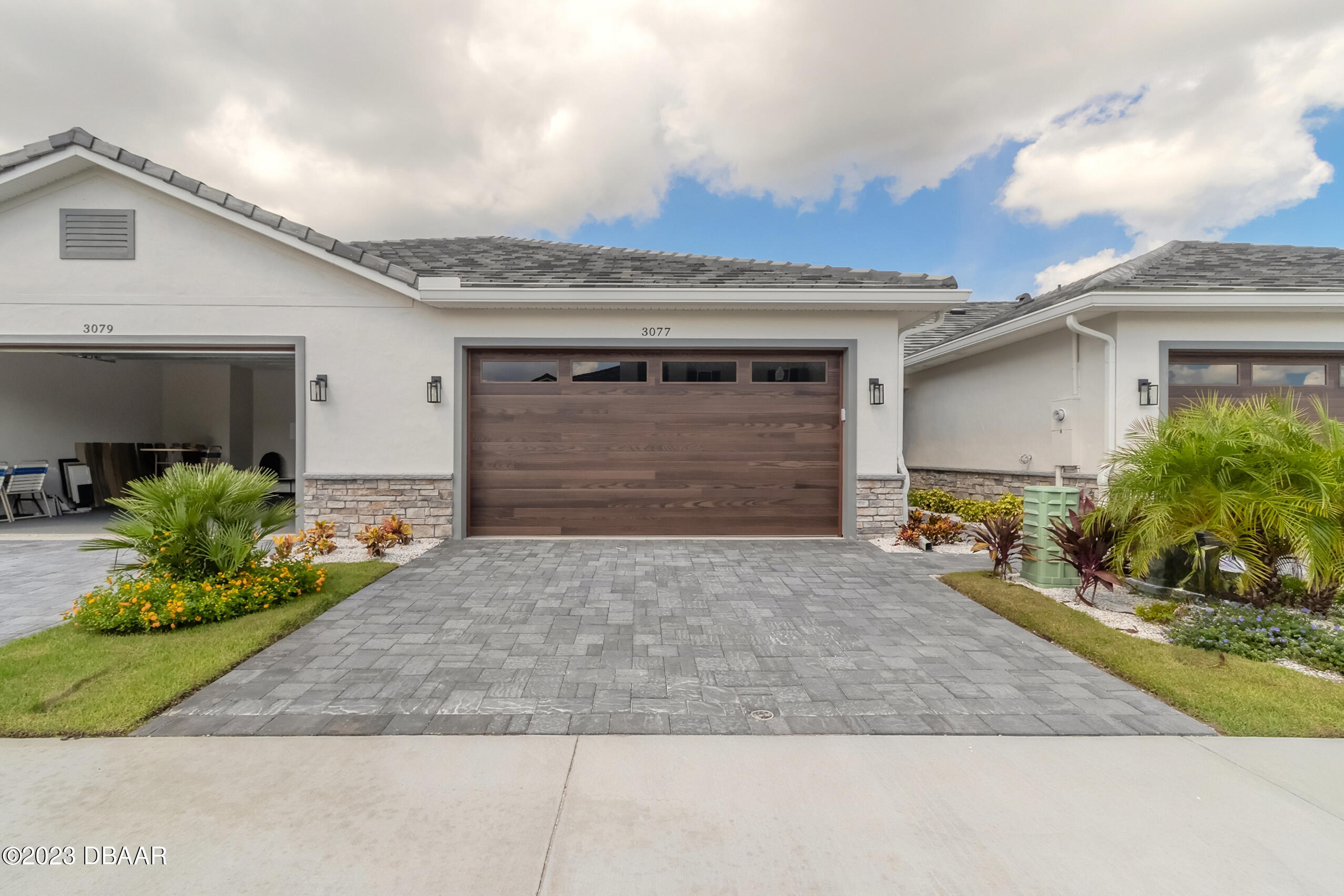 a front view of a house with a yard and garage