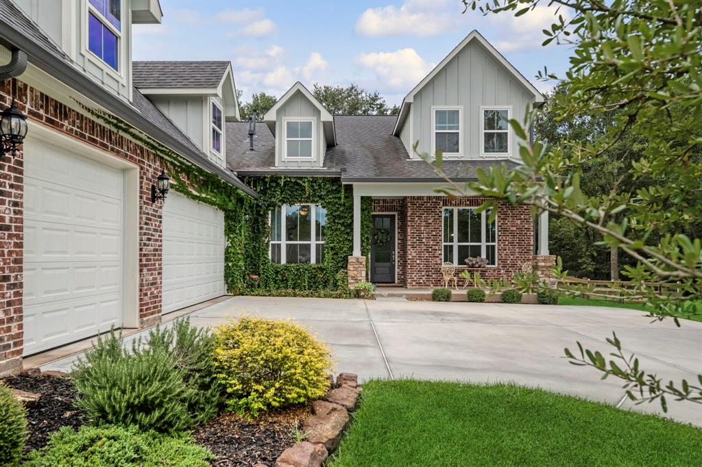 a front view of a house with a yard and potted plants