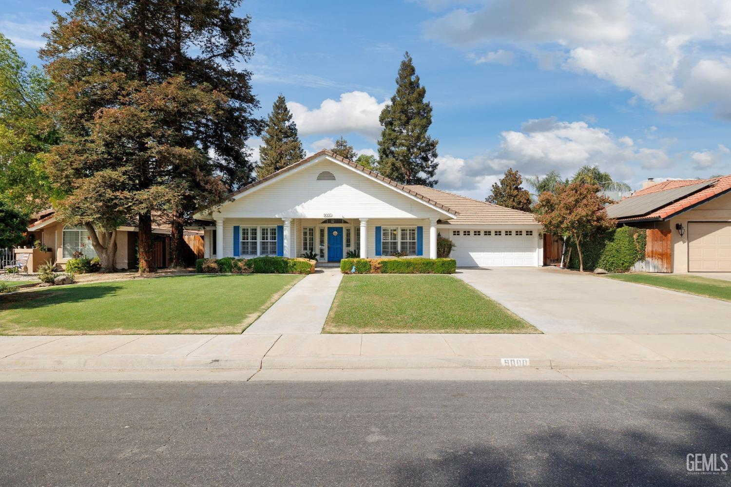 a front view of house with yard and green space