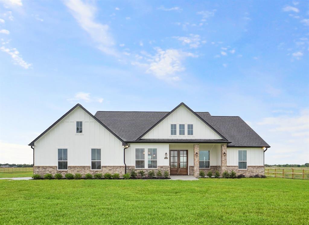 a front view of house with yard and green space